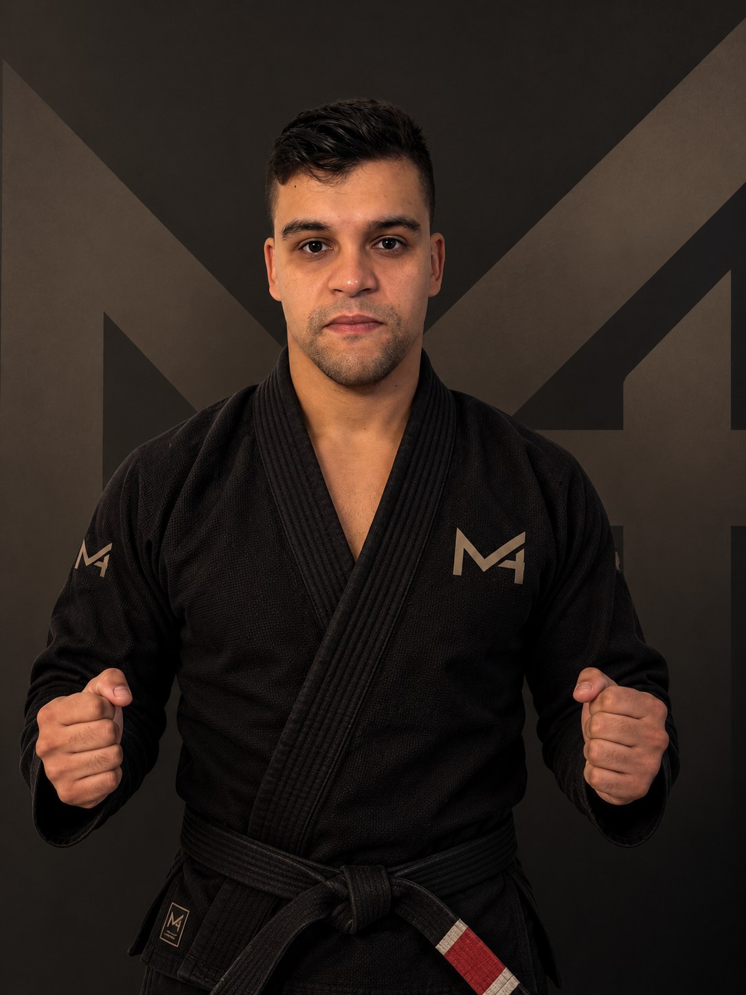 Portrait of Matheus de Moraes in a black M4 gi and black belt